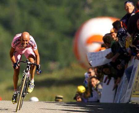 Marco Pantani riding his bike in a pink jersey.