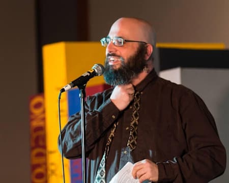 Game designer Dave Azbug presenting at a conference A photograph of game designer and Bradley University professor Dave Azbug