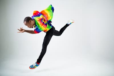 Lil Buck jumps while dancing.