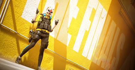 Screenshot from The Finals shows a character with a mask in front of a yellow wall.
