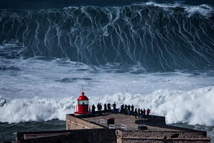 A surfer drops down the face of a huge wave at Nazare, Portugal.