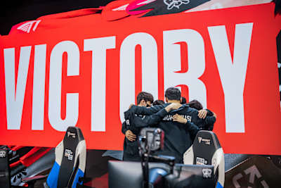 T1 huddles onstage after victory against Royal Never Give Up at the League of Legends World Championship Quarterfinals on October 21, 2022 in New York City.