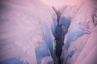 Climber Will Gladd descends a moulin in low light during his trip to explore the Greenland ice cap in 2018.