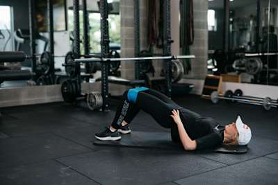 Zoi Sadowski doing a banded glute bridge.