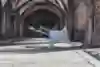 Roxrite posing on one hand with his legs in the air and the second hand touching his cap