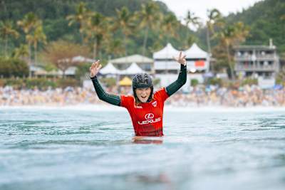 Surfer Caitlin Simmers celebrates in the water after winning the 2024 Lexus Pipe Pro.