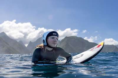 Caity Simmers sits in the lineup at Teahupo'o in Tahiti