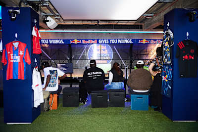 Gamers gather at Red Bull Gaming Sphere in London for the EA Sports FC 26 launch event in September 2025, surrounded by football shirts and gaming setups.