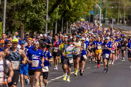 Participants take part in the Wings for Life World Run Flagship Run in Poznan, Poland, on 10 May 2026, filling the tree-lined road with runners