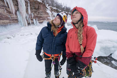 An image of climbers Sasha DiGiulian and Angela VanWiemeersch bundled up in the frigid Michigan conditions.