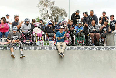 At a Skate for a Cause event, Scheckler (clapping) puts the fun in fundraising.