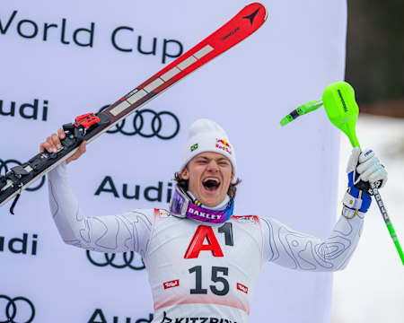 Lucas Pinheiro Braathen lifts his skis in triumph at the Kitzbühel Audi FIS Ski World Cup event in Austria, January 2025. 