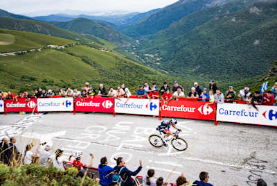 Primož Roglič of Red Bull - BORA - hansgrohe climbs Puerto de Ancares ahead of Ben O'Connor during Stage 13 of La Vuelta 2024 in Spain