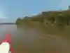 Kayaker Tarran Kent-Hume paddles past an Amazon village on a 6,500km paddle down the World's longest river