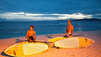 Kai Lenny (left) and Robby Naish (right) on a beach, April 16 2010.