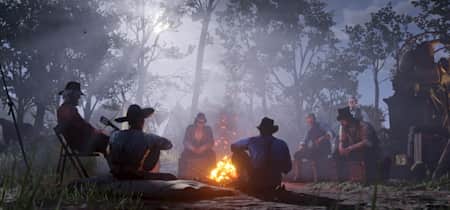 Screenshot aus Red Dead Redemption 2 zeigit die Gang am Lagerfreuer. Wir stellen euch die besten Mods für das Game vor.