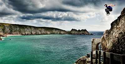Phil Doyle jumping of a rock during a roadtrip to the Minack theatre in Penzance.