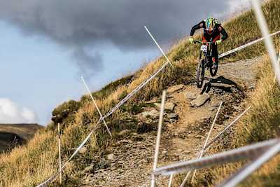Rob Warner rides a drop at the British Downhill Series Legends race at Antur Stiniog