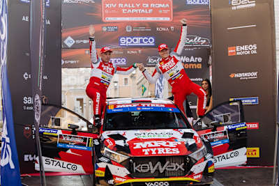 Cais (right) celebrates finishing his 100th rally