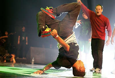 Ronnie Ruen does a one-handed variation of a head hollow back