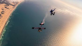A member of the Red Bull Airforce dives towards a Cessna plane with a modified airbrake during training for the Plane Swap project.