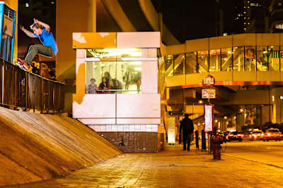 Skater Marius Syvanen alley oop ollies to axle stall in downtown Hong Kong during filming of the Hidden Colony video