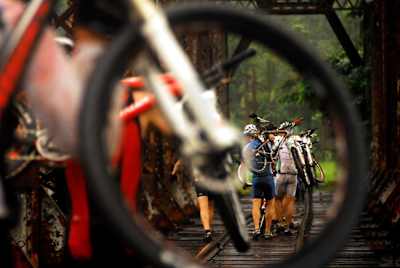 Los competidores cargan con sus bicis durante La Ruta.