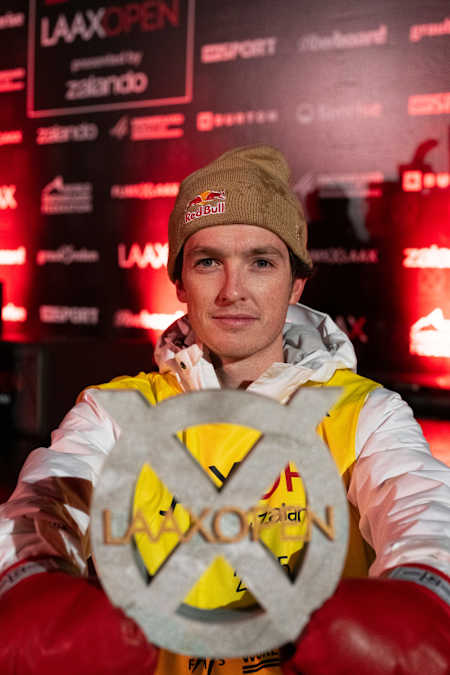 Scotty James celebrates his victory at the Laax Open snowboard halfpipe event
