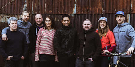 Dan, Gee and Rachel Atherton pose with their team in the Dyfi, Wales on January 12, 2018.