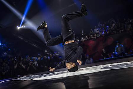 Sunni spinning on his head with the crowd in the background.