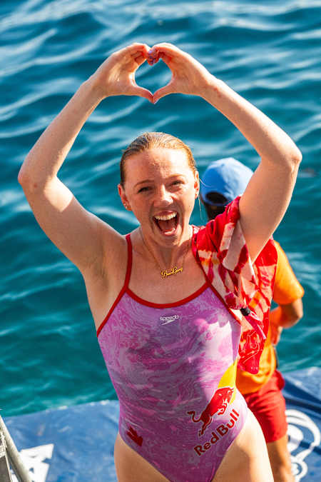 Molly Carlson celebrates after a successful cliff dive.