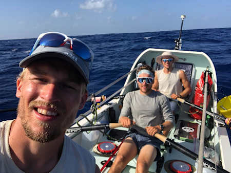 The MacLean brothers pose for a photo during their Atlantic row