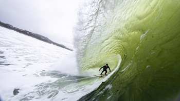Fish-eye shot of surfer Conor Maguire deep in a tube in Mullaghmore, Sligo, Ireland