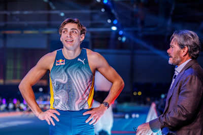 Armand Duplantis smiles while talking to his father and coach, captured at the Mondo Classic 2025.