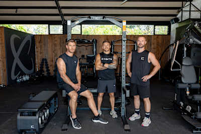 Luke Zocchi and Chris Hemsworth in a gym during a training session.