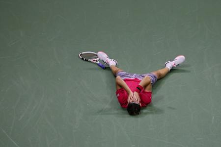 Dominic Thiem lies on the floor after his last point win at the US Open 2020.