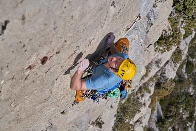 Climber makes his way up rock face in Spain.