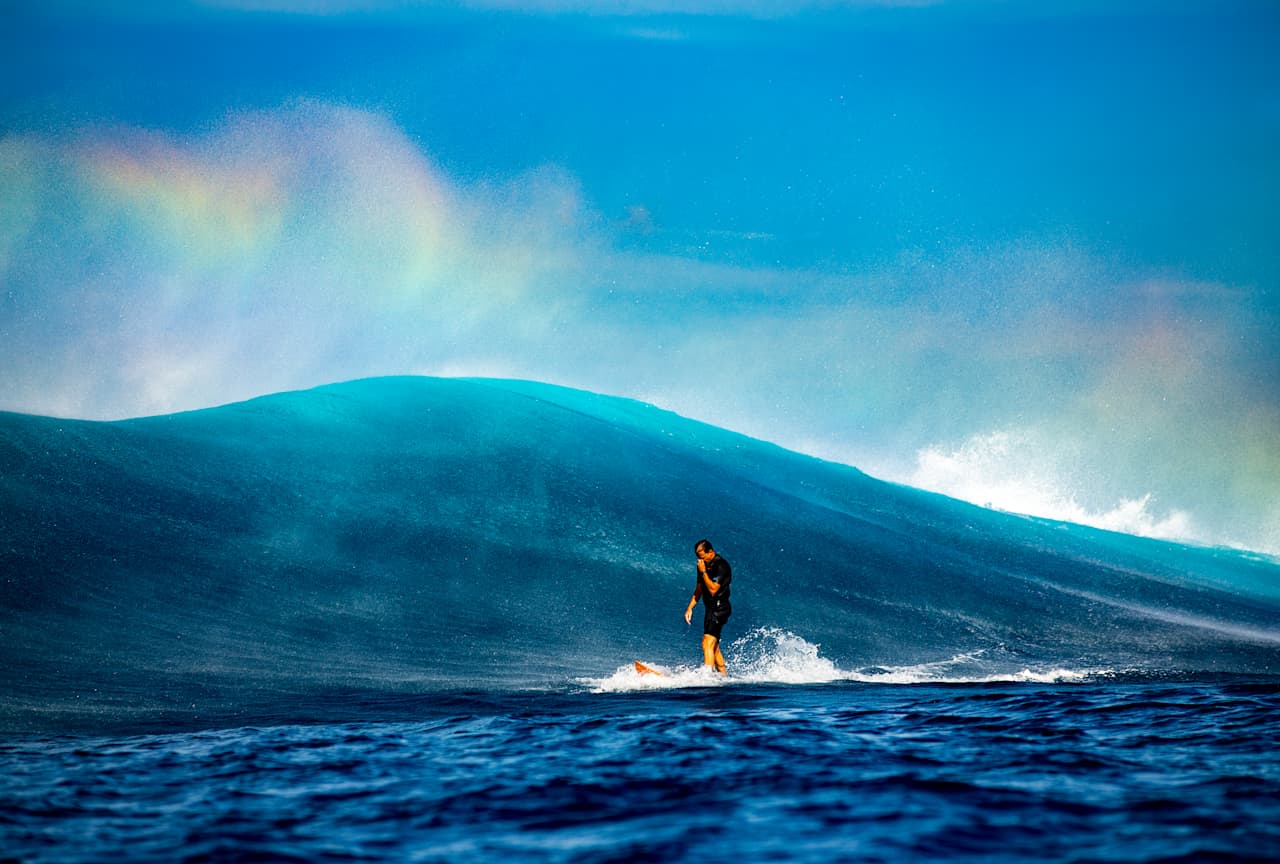 Julian Wilson kicks off a big wave in Fiji. 