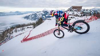 Max Stöckl tears down the snowy Streif ski run.