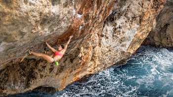 Angie Scarth-Johnson free climbing above the waves. 