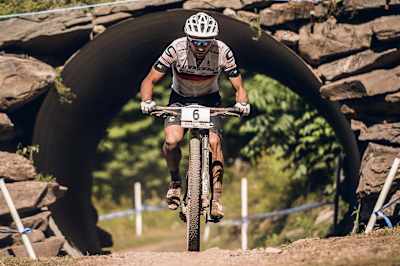 Manuel Fumic goes under the bridge during the 2015 Windham XCO World Cup on August 9, 2015
