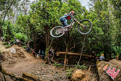 Laurie Greenland clears a log jump during his run at Red Bull Hardline in Tasmania in 2025.