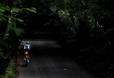 A cyclist climbing a road late into an Everest attempt.