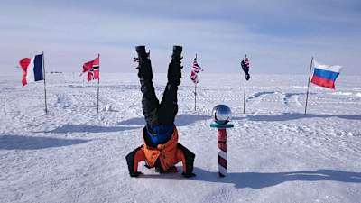 Cancer survivor and explorer Sean Swarner does a headstand at South Pole after reaching the most Southerly place on Earth