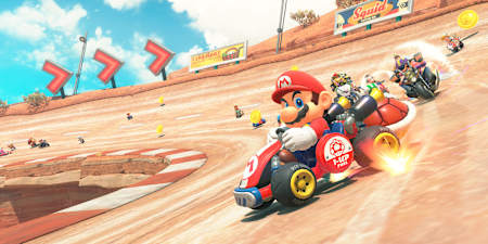 Mario et d'autres personnages du jeu Mario Kart World sur Nintendo Switch 2 dérapent sur un circuit dans le désert.