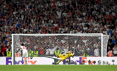 Gianluigi Donnarumma of Italy saves Bukayo Saka's penalty during the penalty shoot out in the Euro 2020 Final at Wembley Stadium on July 11, 2021 in London, England.