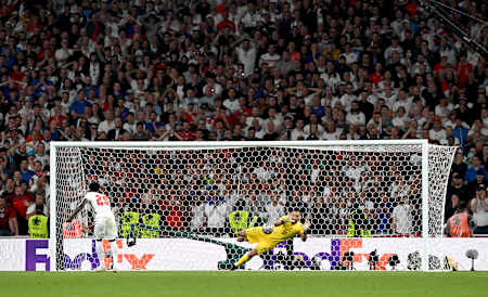Gianluigi Donnarumma of Italy saves Bukayo Saka's penalty during the penalty shoot out in the Euro 2020 Final at Wembley Stadium on July 11, 2021 in London, England.