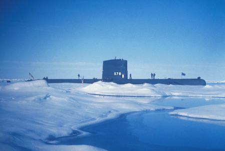 A US Navy Seawolf Submarine breaks the surface ice in the Arctic Circle