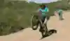 Mountain biker Wyn Masters demonstrates how to perform a manual wheelie
