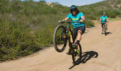 Mountain biker Wyn Masters demonstrates how to perform a manual wheelie